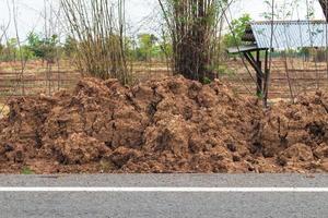 The pile of dirt near the asphalt road. photo