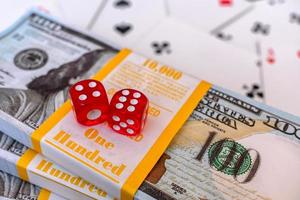 Red dice lie on the money bet in the casino photo