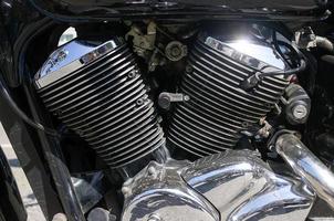 Chrome Cylinders Motorcycle Engine with Light Reflection photo