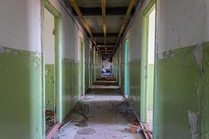 Long and empty corridor in a hospital building abandoned and destroyed after an earthquake photo