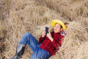 Asian farmer with rice stubble in the field photo