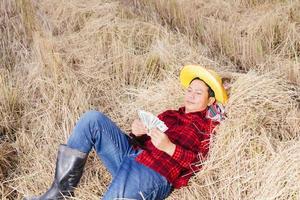 Asian farmer with rice stubble in the field photo