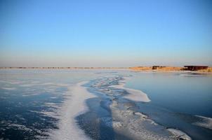 long crack in the frozen lake photo