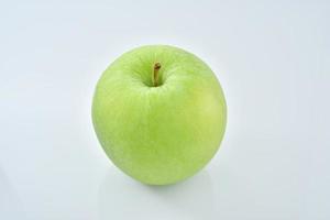 a green apple on a white background photo