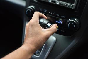 Hand holding the gear lever in the car photo