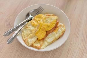 fried eggs in a white plate photo