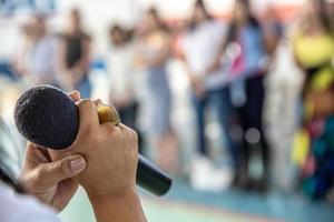 Person holding microphone photo