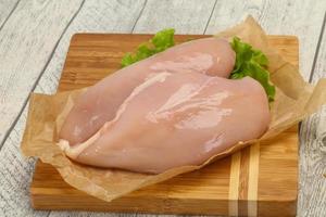 Raw chicken breast ready for cooking photo