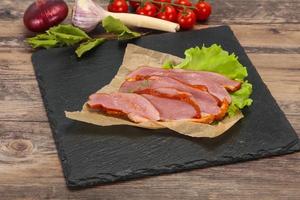 Sliced smoked duck breast served salad photo