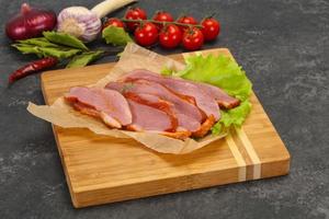 Sliced smoked duck breast served salad photo