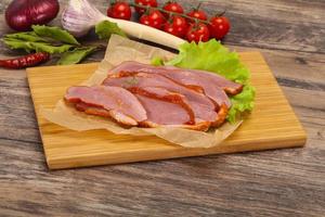 Sliced smoked duck breast served salad photo