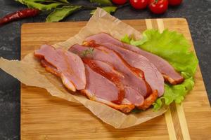 Sliced smoked duck breast served salad photo