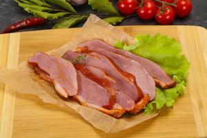 Sliced smoked duck breast served salad photo