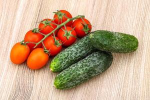 Cucumbers and tomatoes on the branch photo