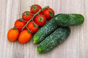 Cucumbers and tomatoes on the branch photo