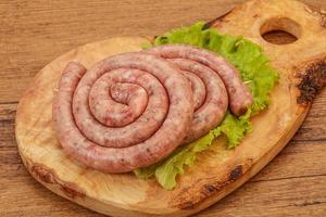 Raw sausage ring for grill photo