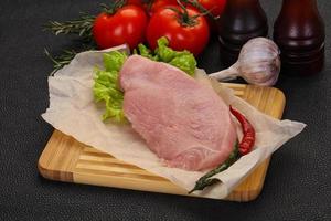 Raw Turkey steak served rosemary photo