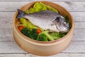 Steamed dorada with vegetables photo
