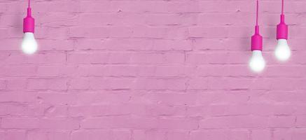 Pink brick wall with light bulbs. Creative copy space for your text or image. Banner format photo