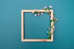 Square wooden frame mock up with decorative floral ornaments with copy space top view photo