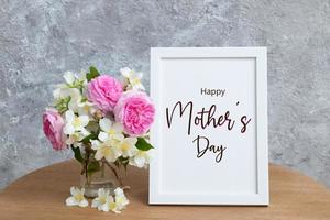 Happy Mothers Day greeting text in white frame with flowers photo