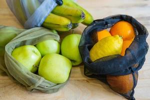 Colorful fresh fruits vegetables and eggs  in eco friendly bags photo