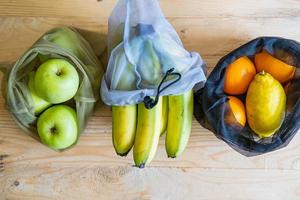 Colorful fresh fruits vegetables and eggs  in eco friendly bags photo