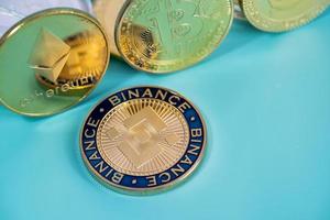 Close up Binance Coin BNB group included with Crypto currency coin Dogecoin DOGE, bitcoin BTC, Ethereum ETH symbol Virtual blockchain technology future is money blue background and Macro concept. photo