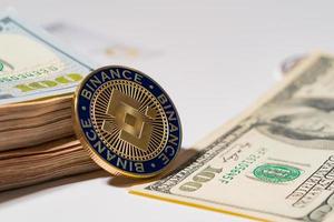 Binance Coin BNB included with Cryptocurrency coin on stack hundred US dollar Money American blockchain technology future money Close up and Macro background photo