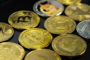 Close up Golden bitcoin BTC Dogecoin DOGE group included with Cryptocurrency Ethereum ETH, Stellar XLM symbol Virtual blockchain technology future is money concept and Macro photography. photo