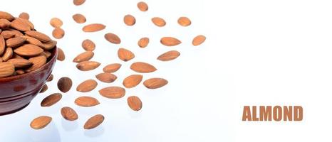 Almonds in a clay pot isolated on a white background photo