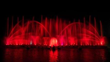 The colorful fountain dancing in celebration of year with dark night sky background. photo