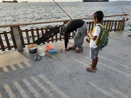 Male, Maldives, April 2021-People fishing on the beach photo