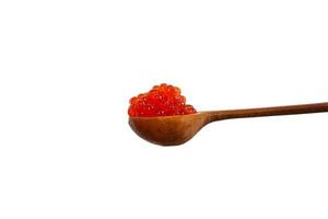 Red caviar in the wooden spoon isolated on white background. photo