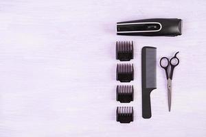 Hairdresser tools on wooden background. Haircut accessories concept. Top view photo
