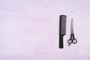 Hairdresser tools on wooden background. Haircut accessories concept. Top view photo