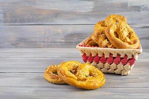 Homemade baked salt pretzel on wooden background. Oktoberfest concept photo