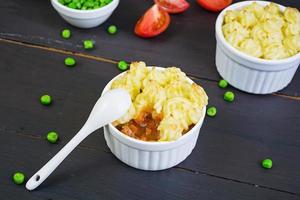 Homemade shepherd's pie on wooden background photo