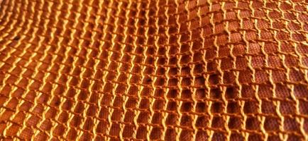 Gold orange honeycomb net patterns backgrpund. Synthetic honeycom net structure fabric background design. Available for text. Suitable for poster, backdrop, presentation, wallpaper, advertising, etc. photo