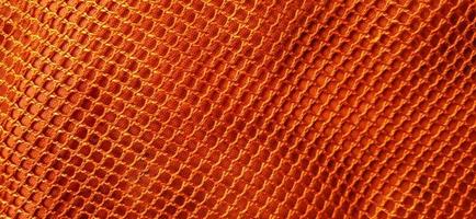 Gold orange honeycomb net patterns backgrpund. Synthetic honeycom net structure fabric background design. Available for text. Suitable for poster, backdrop, presentation, wallpaper, advertising, etc. photo