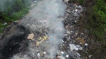 Aerial fly away open burning at rubbish dump site video