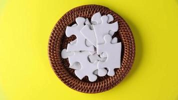 Rotation of white jig saw puzzle video