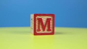 Close up shot letter M alphabet wooden block video