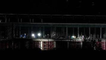 Time lapse of workers working at the construction site of large reinforced concrete structures. A large construction site with workers working at night. video