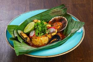 Bouillabaisse soup in the banana leaf photo