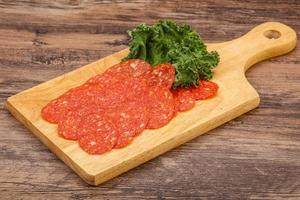 Italian spycy pepperoni sausage slices photo