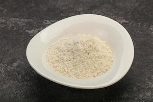 Wheat flour heap in the bowl photo