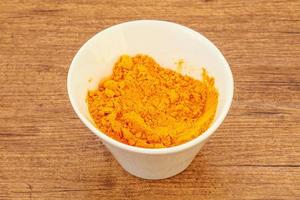 Tumeric powder in the bowl photo