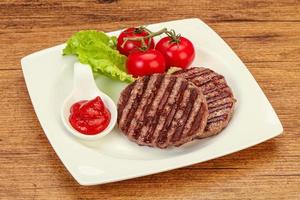 Grilled burger cutlet with sauce photo