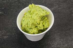 Avocado guacamole sauce with chili pepper photo